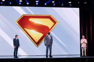 Peter Safran, Shaq, and James Gunn speak onstage during Warner Bros. Discovery’s 2025 Upfront Presentation at The Theater at Madison Square Garden on May 14, 2025 in New York City | Image via: Getty